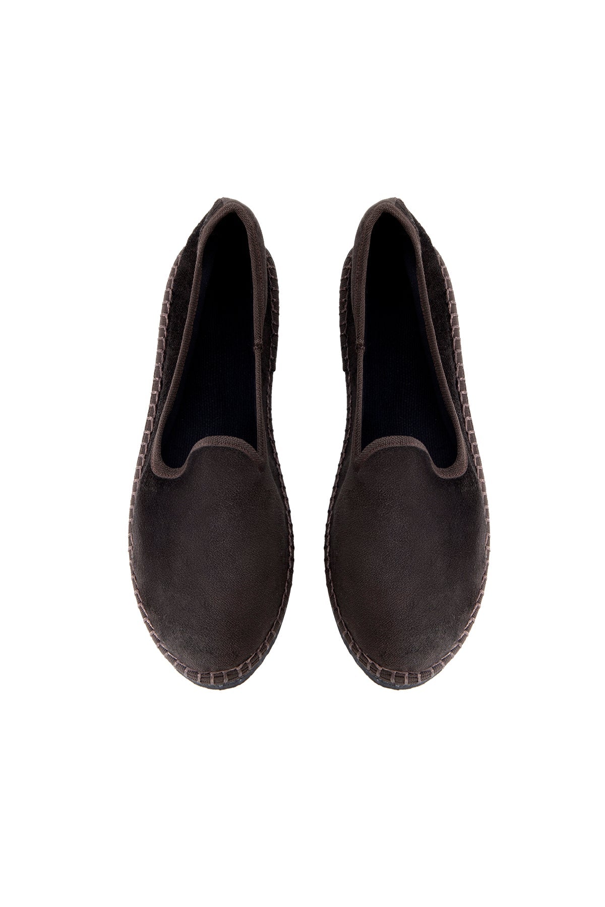 Pair of black slip-on shoes on a white background