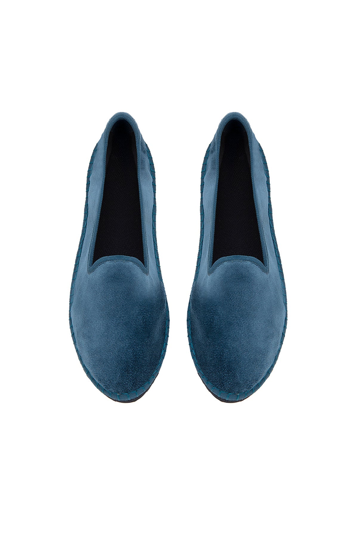 Pair of blue loafers on a white background