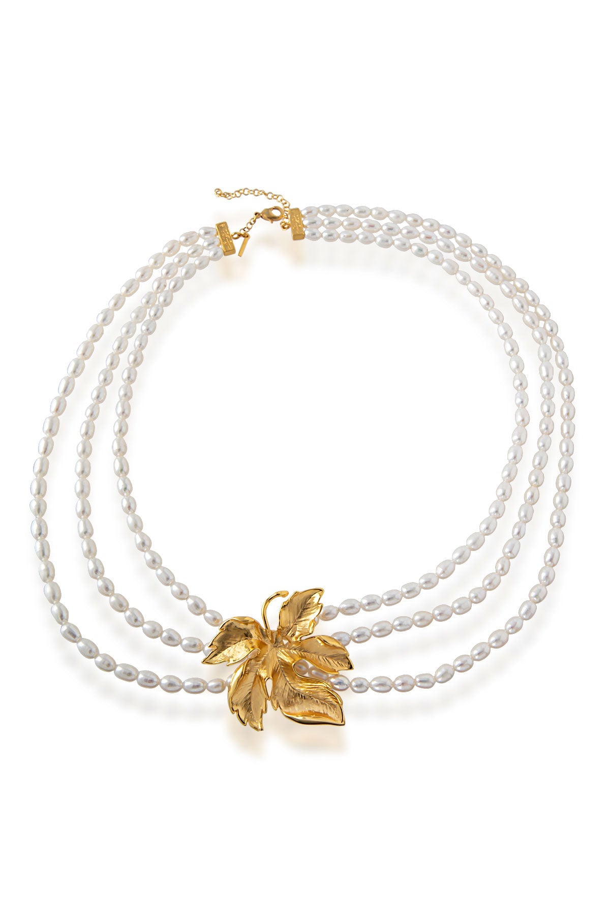 A gold-plated bronze necklace with baroque pearls and a central gold floral pendant.