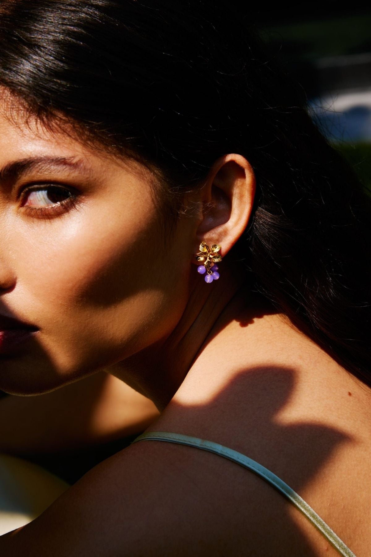 Close-up of a woman wearing earrings with a blurred background