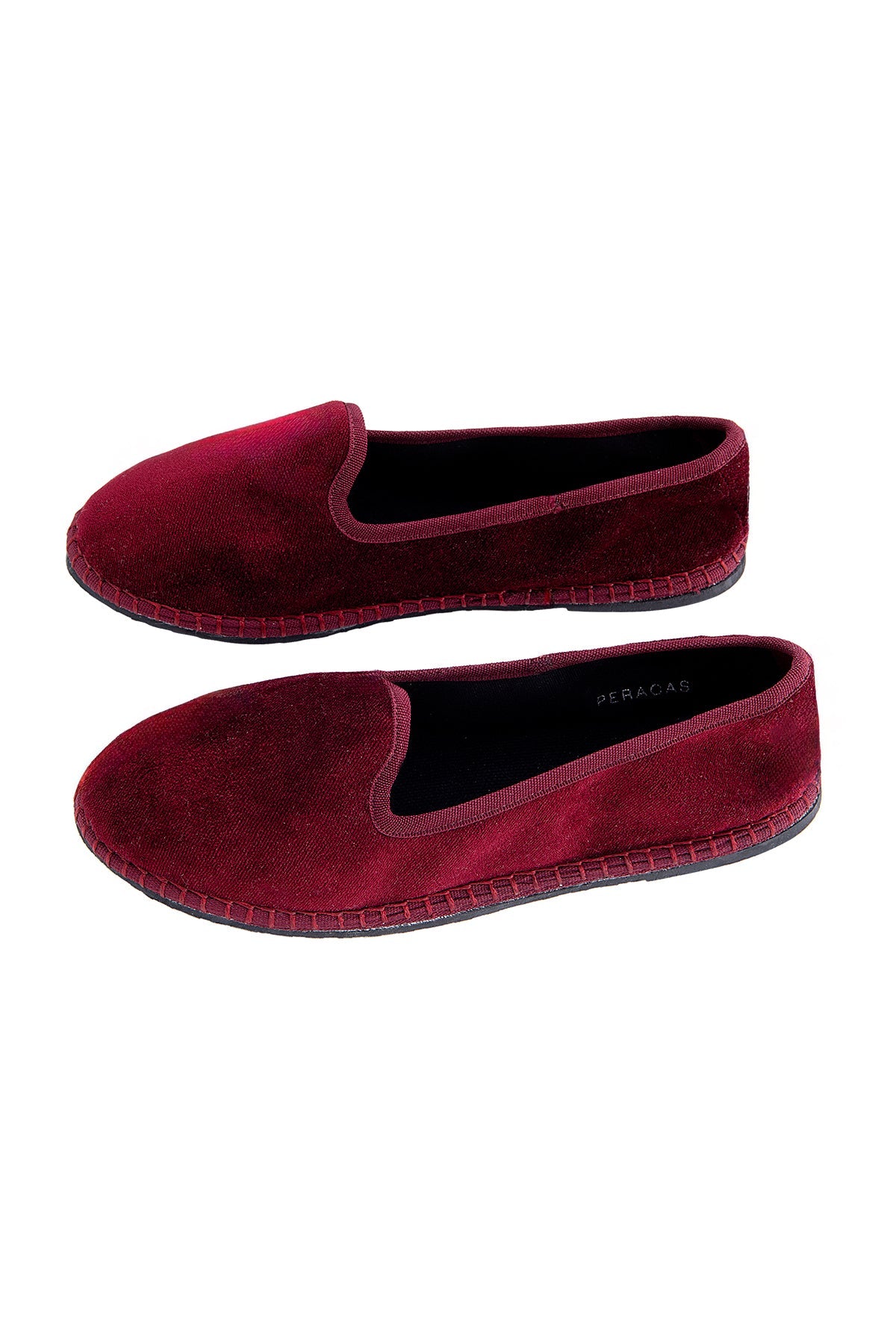 Pair of maroon velvet slippers on a white background