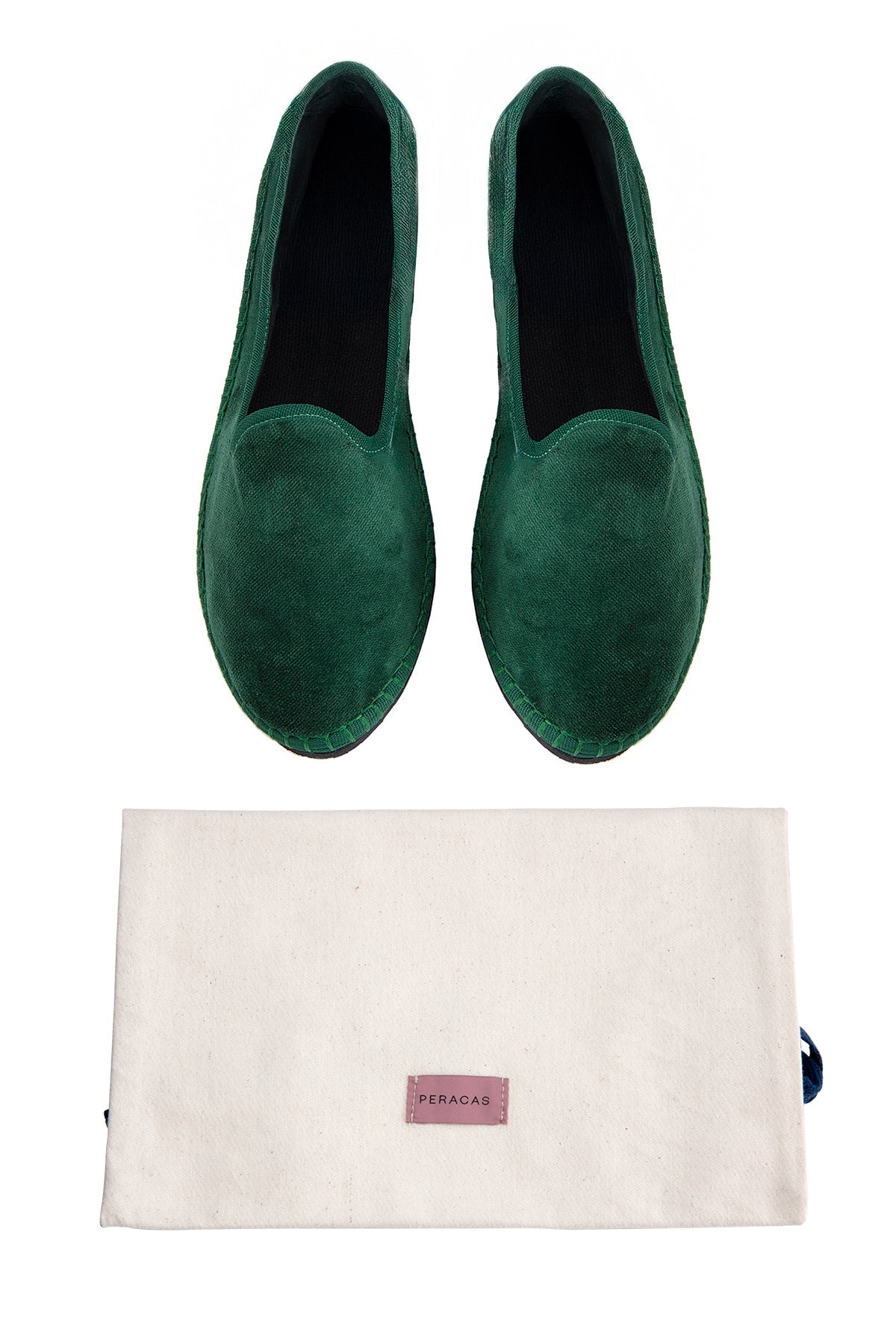 Pair of green loafers with a beige pouch on a white background