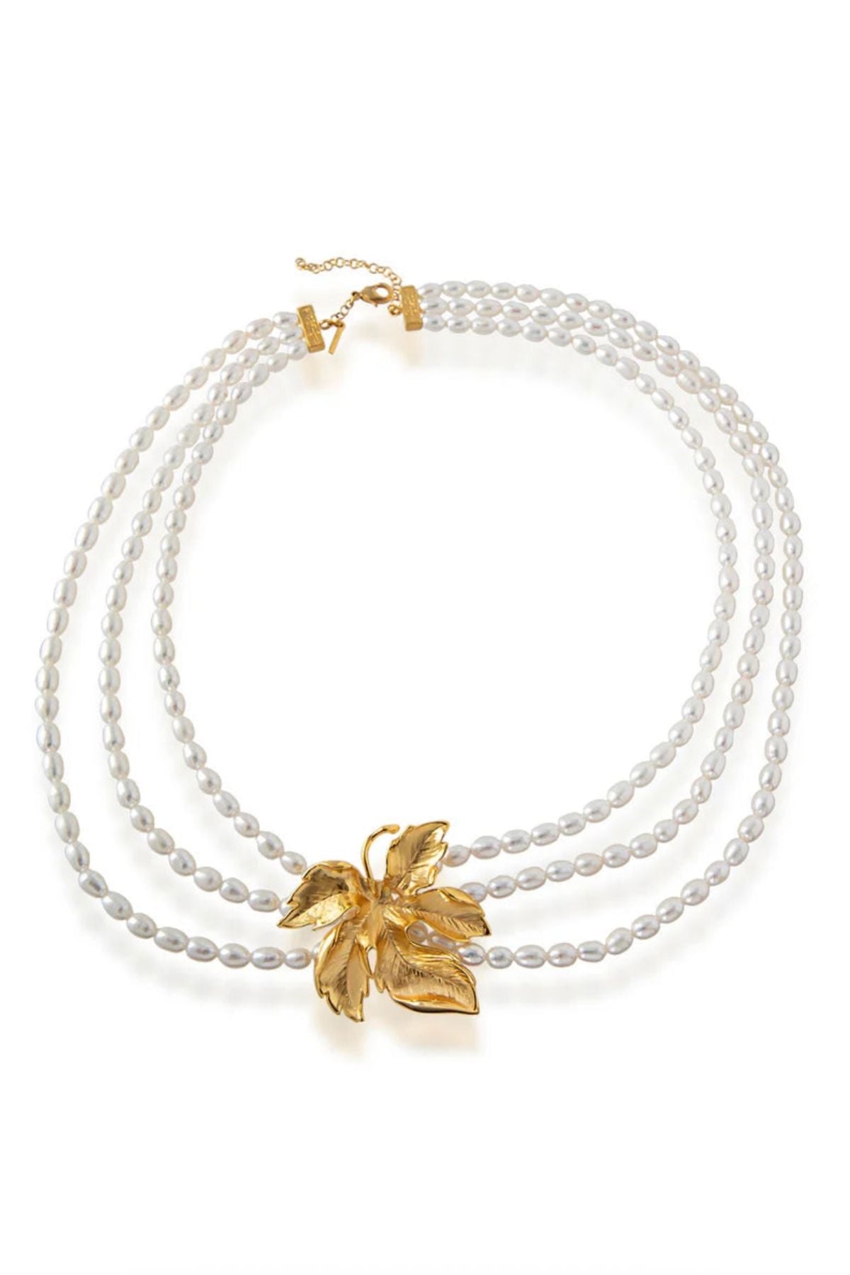 Three pearl necklaces with gold leaf pendants on a white background