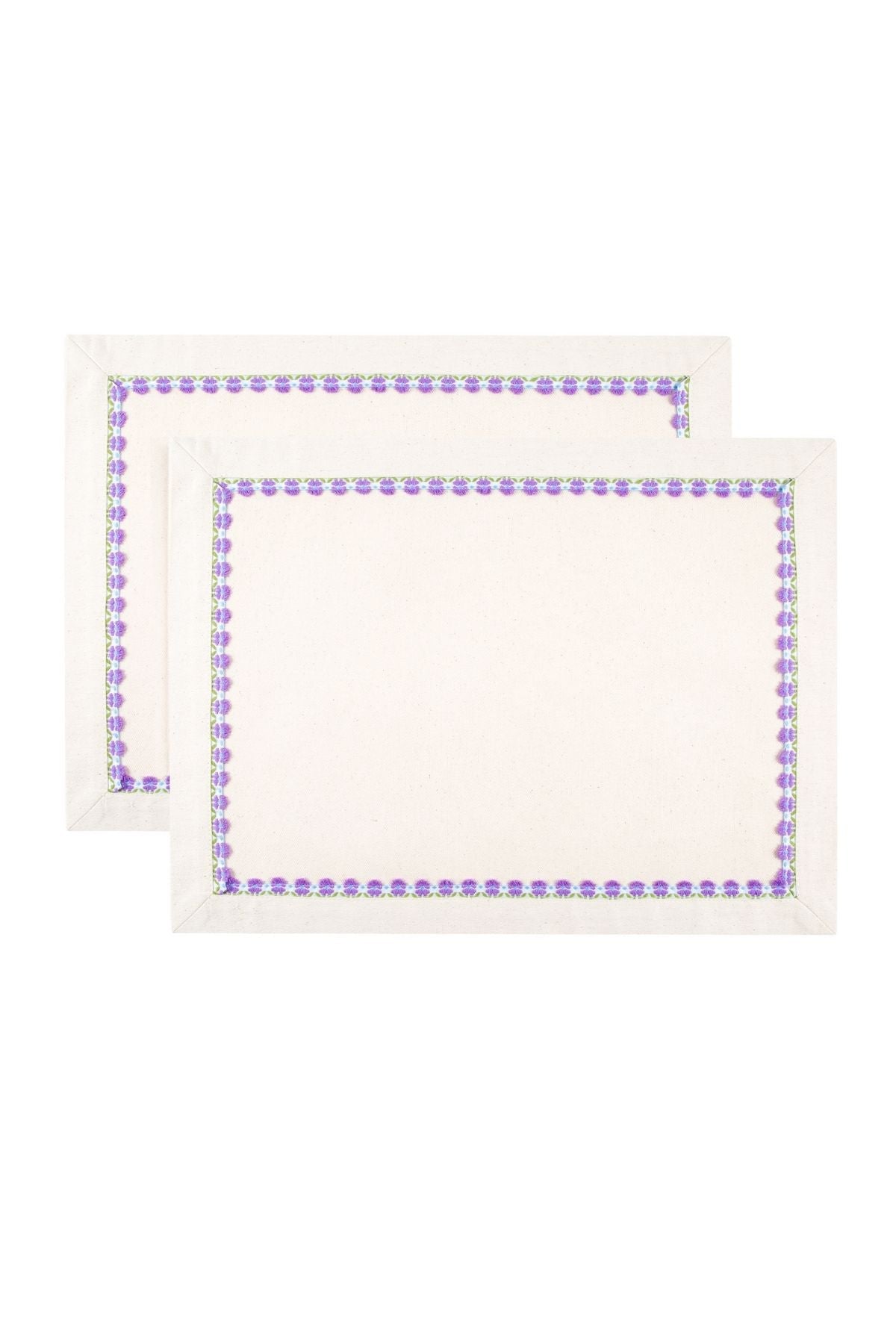 Two white placemats with purple border design on a white background
