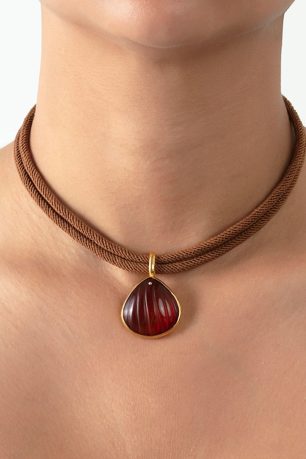 Necklace with a red pendant on a mannequin