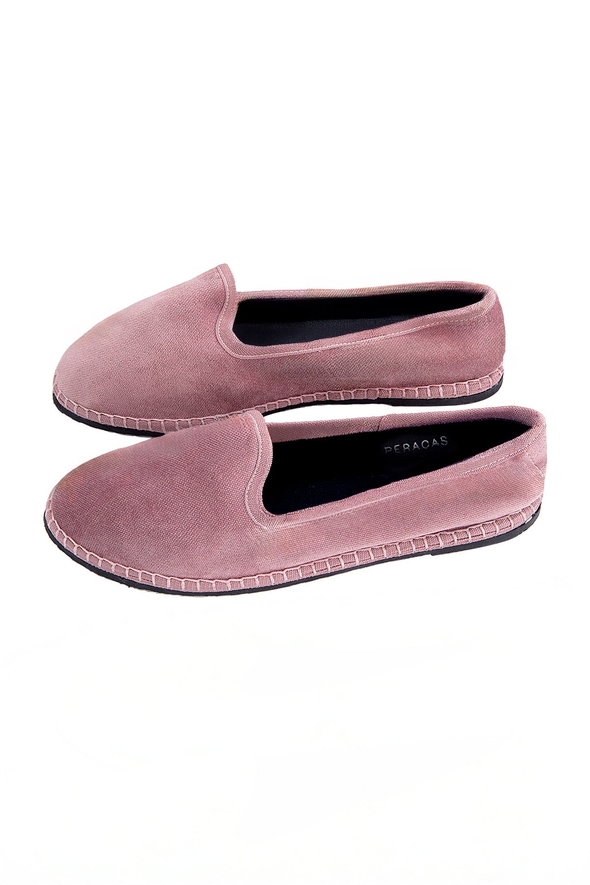 Pair of pink slip-on shoes on a white background