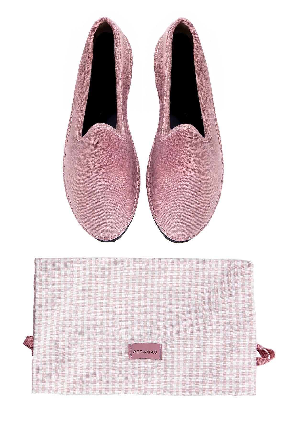Pair of pink velvet slippers with a matching pouch on a white background
